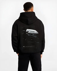 Black hoodie worn by a male model, back view, featuring BMW 750I rs turbo motorsport euro german street graphic.