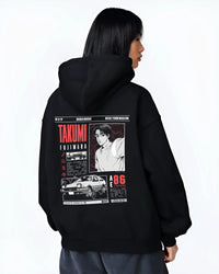 Black hoodie worn by a female model, back view, featuring AE86 racing drift japanese initial d street retro performance graphic.