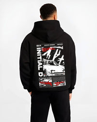 Black hoodie worn by a male model, back view, featuring Toyota AE86 racing drift jdm tuner initial d street graphic.