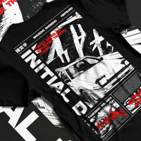 Black T-shirt laid flat with natural fabric folds, featuring Toyota AE86 racing drift jdm tuner initial d street graphic.