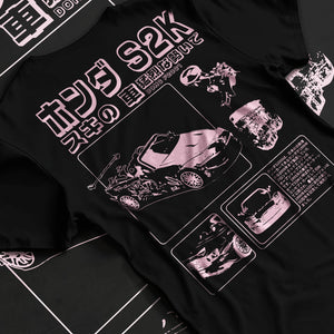 Black T-shirt laid flat with natural fabric folds, featuring Honda S2000 jdm japanese street retro racing performance graphic.