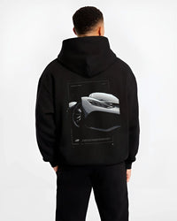 Black hoodie worn by a male model, back view, featuring Mercedes-Benz AMG rs racing motorsport street performance graphic.