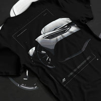Black T-shirt laid flat with natural fabric folds, featuring Mercedes-Benz AMG rs racing motorsport street performance graphic.
