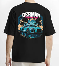 Black T-shirt worn by a male model, back view, featuring Audi R8 german street racing performance motorsport automotive graphic.
