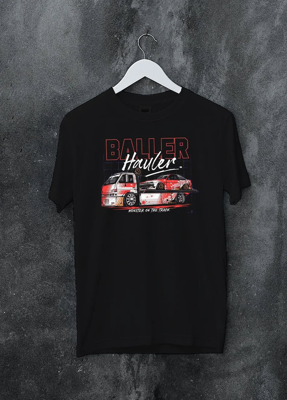 Black crewneck T-shirt on a hanger against a grey wall, featuring racing drift japanese tuner street performance motorsport graphic.