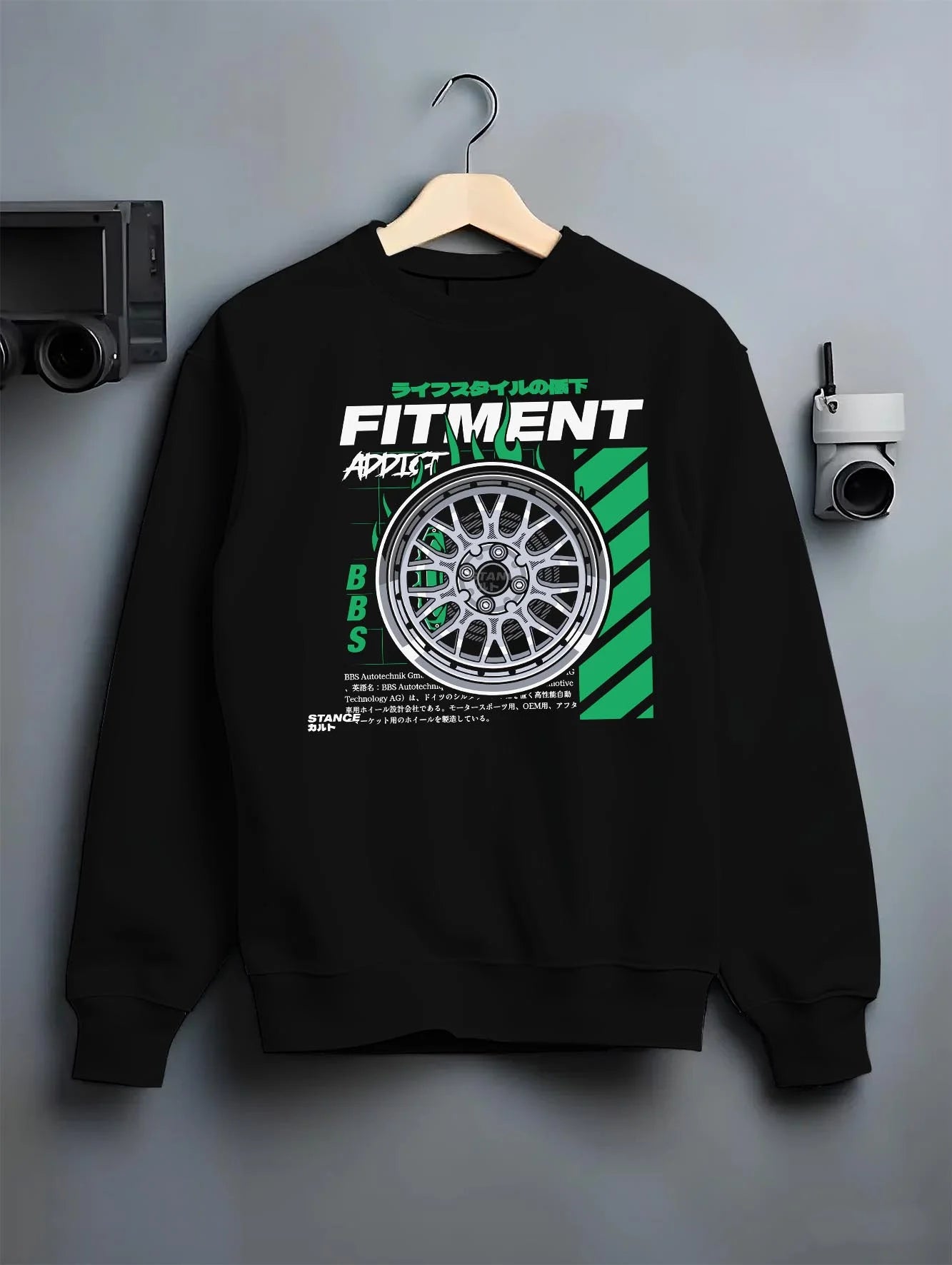 Black crewneck sweatshirt on a hanger against a grey wall, featuring racing jdm stance street performance motorsport graphic.
