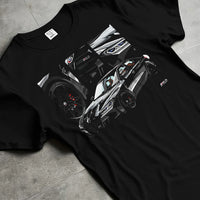 Black T-shirt laid flat with natural fabric folds, featuring BMW M3 rs motorsport german racing street performance graphic.