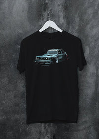 Black crewneck T-shirt on a hanger against a grey wall, featuring BMW E30 rs drift jdm stance widebody racing graphic.
