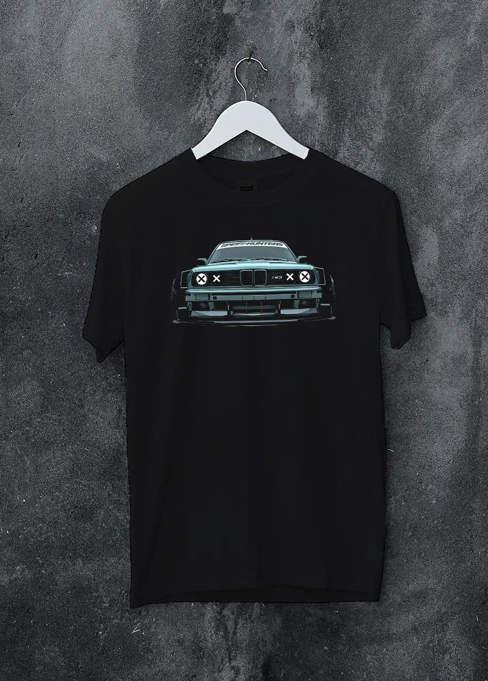 Black crewneck T-shirt on a hanger against a grey wall, featuring BMW M3 rs drift classic racing street performance graphic.