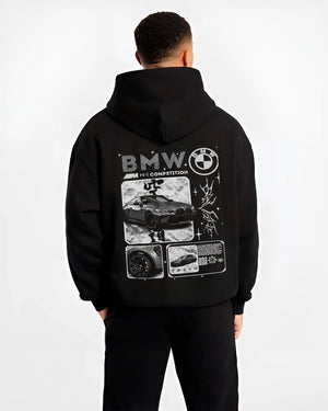 Black hoodie worn by a male model, back view, featuring BMW M4 german racing street performance motorsport automotive graphic.