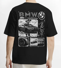 Black T-shirt worn by a male model, back view, featuring BMW M4 german racing street performance motorsport automotive graphic.