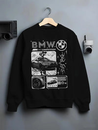 Black crewneck sweatshirt on a hanger against a grey wall, featuring BMW M4 german racing street performance motorsport graphic.