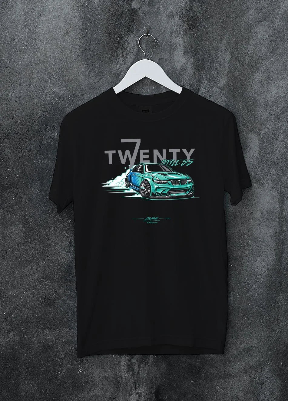 Black crewneck T-shirt on a hanger against a grey wall, featuring BMW turbo drift racing street performance motorsport graphic.