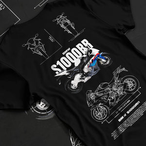 Black T-shirt laid flat with natural fabric folds, featuring BMW S1000RR racing street performance motorsport automotive graphic.