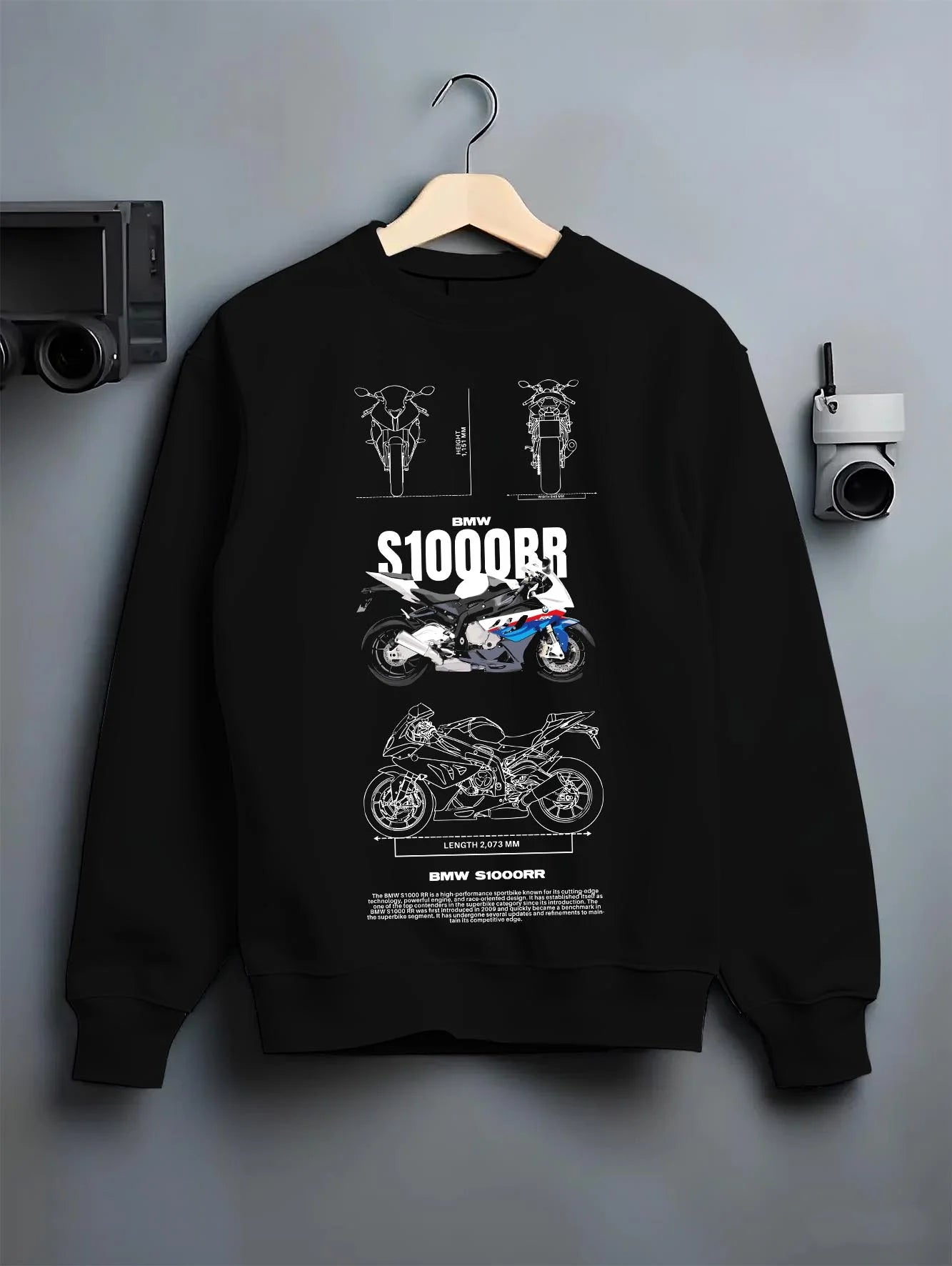 Black crewneck sweatshirt on a hanger against a grey wall, featuring BMW S1000RR racing street performance motorsport graphic.