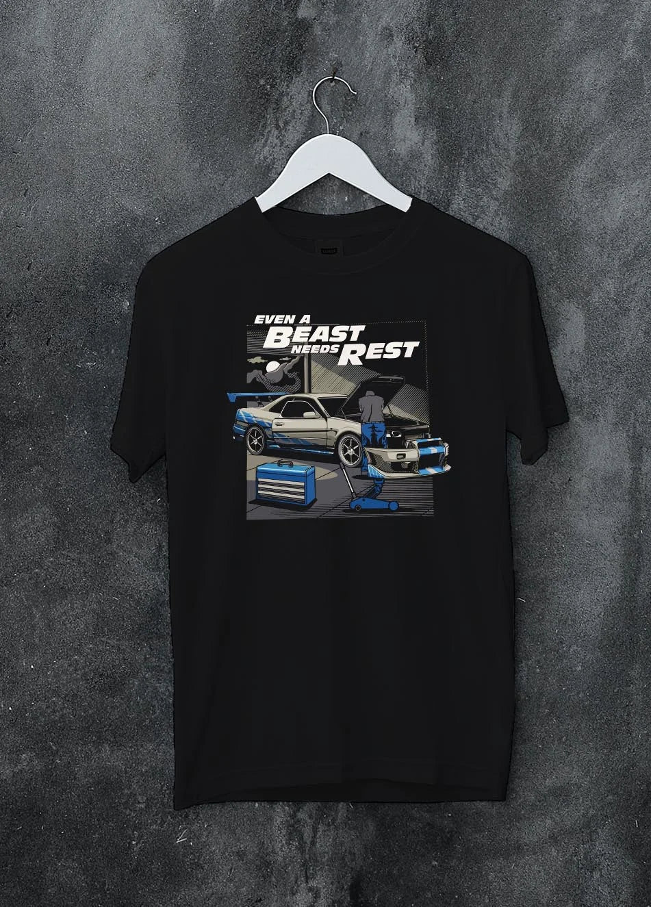 Black crewneck T-shirt on a hanger against a grey wall, featuring racing tuner street retro beast performance motorsport graphic.