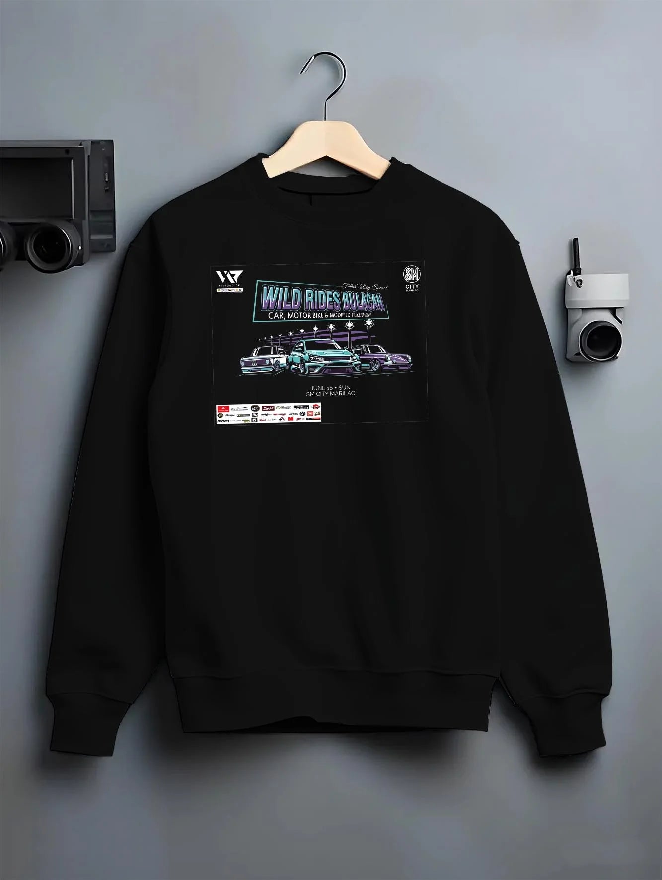 Black crewneck sweatshirt on a hanger against a grey wall, featuring racing tuner street show performance motorsport graphic.