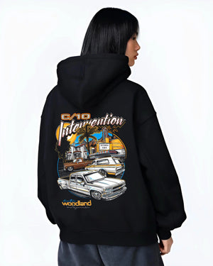 Black hoodie worn by a female model, back view, featuring Chevrolet C10 retro vintage classic racing street performance graphic.