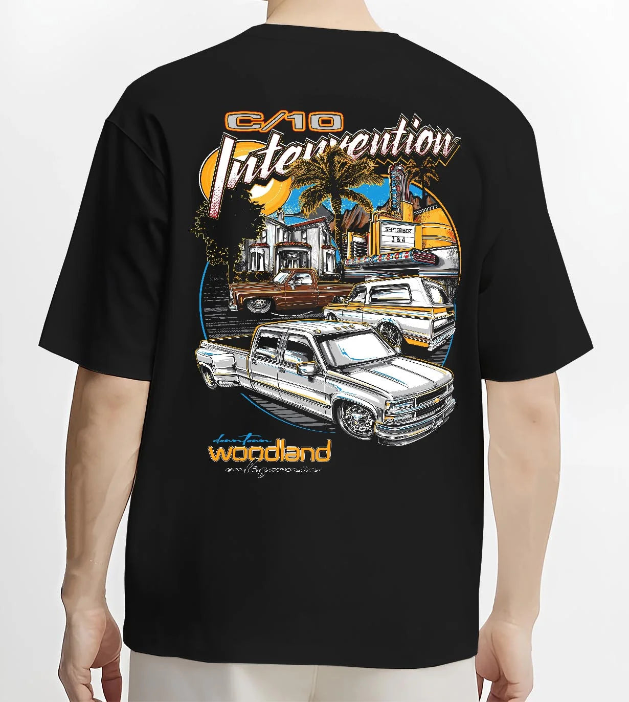 Black T-shirt worn by a male model, back view, featuring Chevrolet C10 retro vintage classic racing street performance graphic.