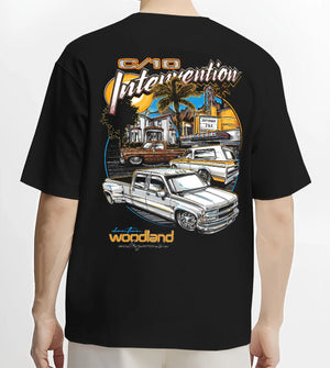 Black T-shirt worn by a male model, back view, featuring Chevrolet C10 retro vintage classic racing street performance graphic.