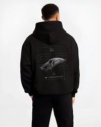 Black hoodie worn by a male model, back view, featuring Chevrolet C10 retro classic enthusiast racing street performance graphic.
