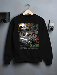 Black crewneck sweatshirt on a hanger against a grey wall, featuring Chevrolet Corvette C8R gt3 rs corvette racing graphic.