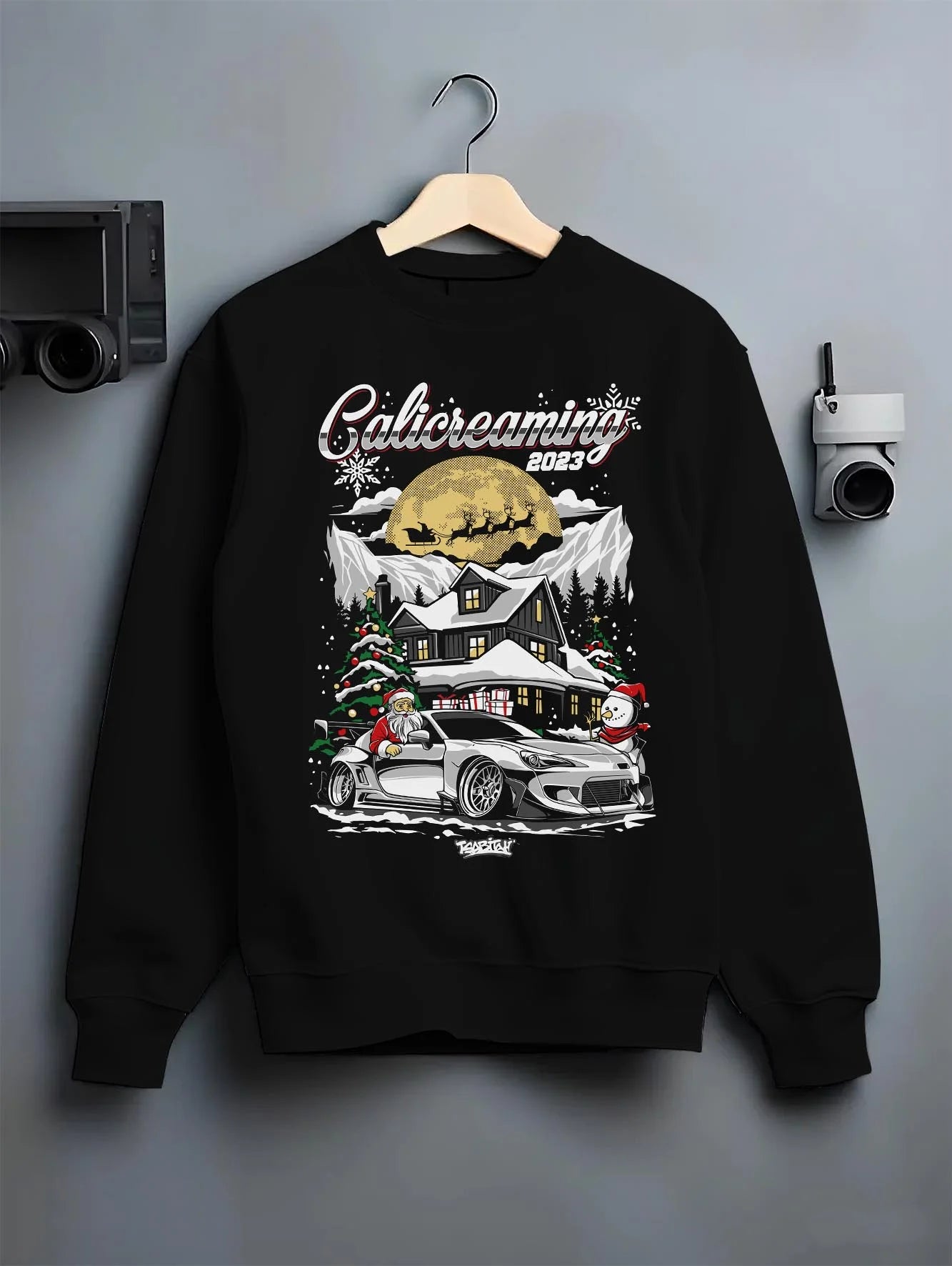 Black crewneck sweatshirt on a hanger against a grey wall, featuring rs drift jdm street racing performance motorsport graphic.