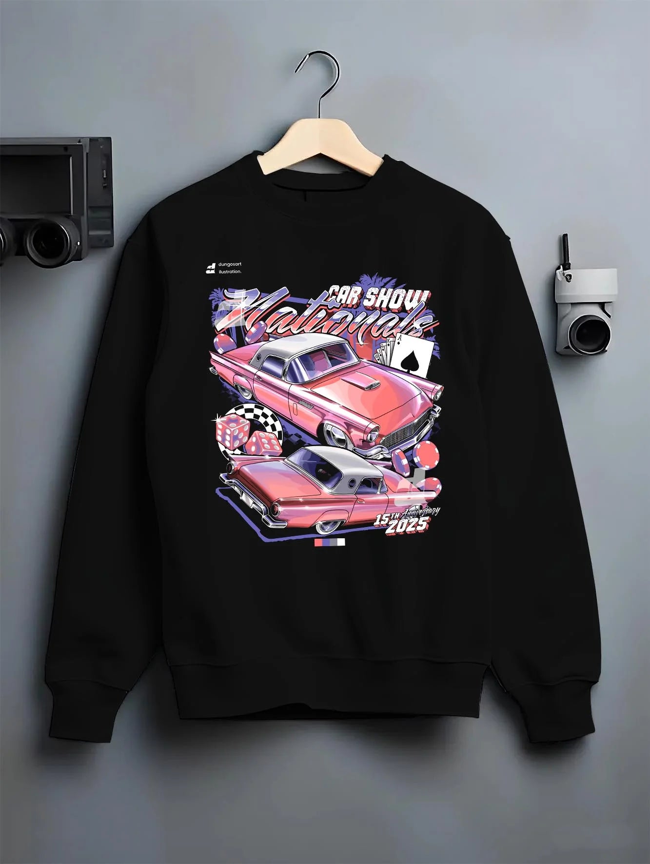 Black crewneck sweatshirt on a hanger against a grey wall, featuring rs ls retro vintage classic show racing street graphic.