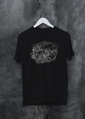 Black crewneck T-shirt on a hanger against a grey wall, featuring street enthusiast racing performance motorsport graphic.