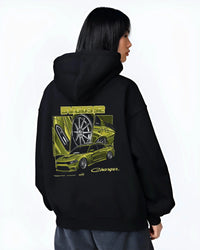 Black hoodie worn by a female model, back view, featuring Dodge Charger racing jdm american muscle street retro graphic.