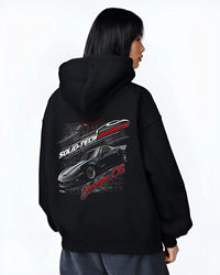 Black hoodie worn by a female model, back view, featuring Chevrolet rs racing muscle street retro classic enthusiast graphic.