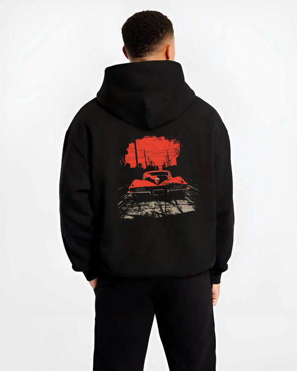 Black hoodie worn by a male model, back view, featuring Chevrolet Corvette muscle retro classic enthusiast racing street graphic.