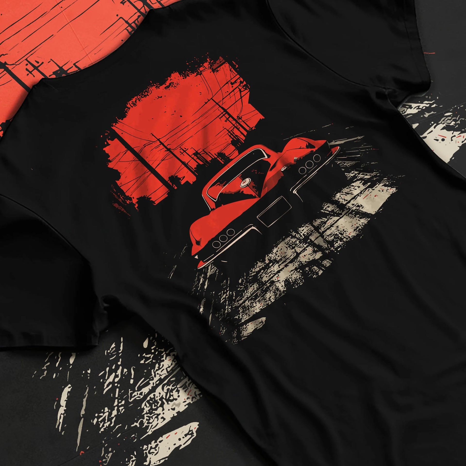 Black T-shirt laid flat with natural fabric folds, featuring Chevrolet Corvette muscle retro classic enthusiast racing graphic.