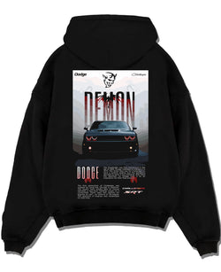 Black pullover hoodie laid flat on a white background, featuring Dodge Challenger racing muscle street retro enthusiast graphic.