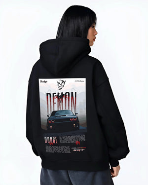 Black hoodie worn by a female model, back view, featuring Dodge Challenger racing muscle street retro enthusiast graphic.