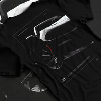 Black T-shirt laid flat with natural fabric folds, featuring Dodge Charger racing muscle street enthusiast performance graphic.