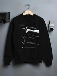 Black crewneck sweatshirt on a hanger against a grey wall, featuring Dodge Charger racing muscle street enthusiast graphic.