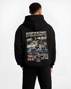 Black hoodie worn by a male model, back view, featuring racing drift jdm tuner street enthusiast show performance graphic.