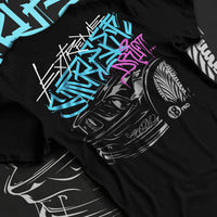 Black T-shirt laid flat with natural fabric folds, featuring drift jdm tuner street enthusiast racing performance graphic.