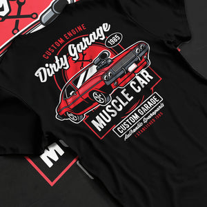 Black T-shirt laid flat with natural fabric folds, featuring muscle street classic enthusiast racing performance motorsport graphic.
