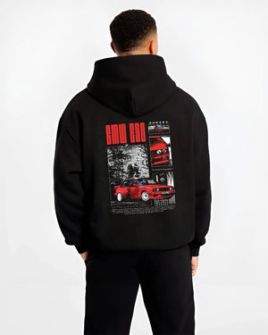 Black hoodie worn by a male model, back view, featuring BMW rs turbo racing drift motorsport euro german street retro graphic.