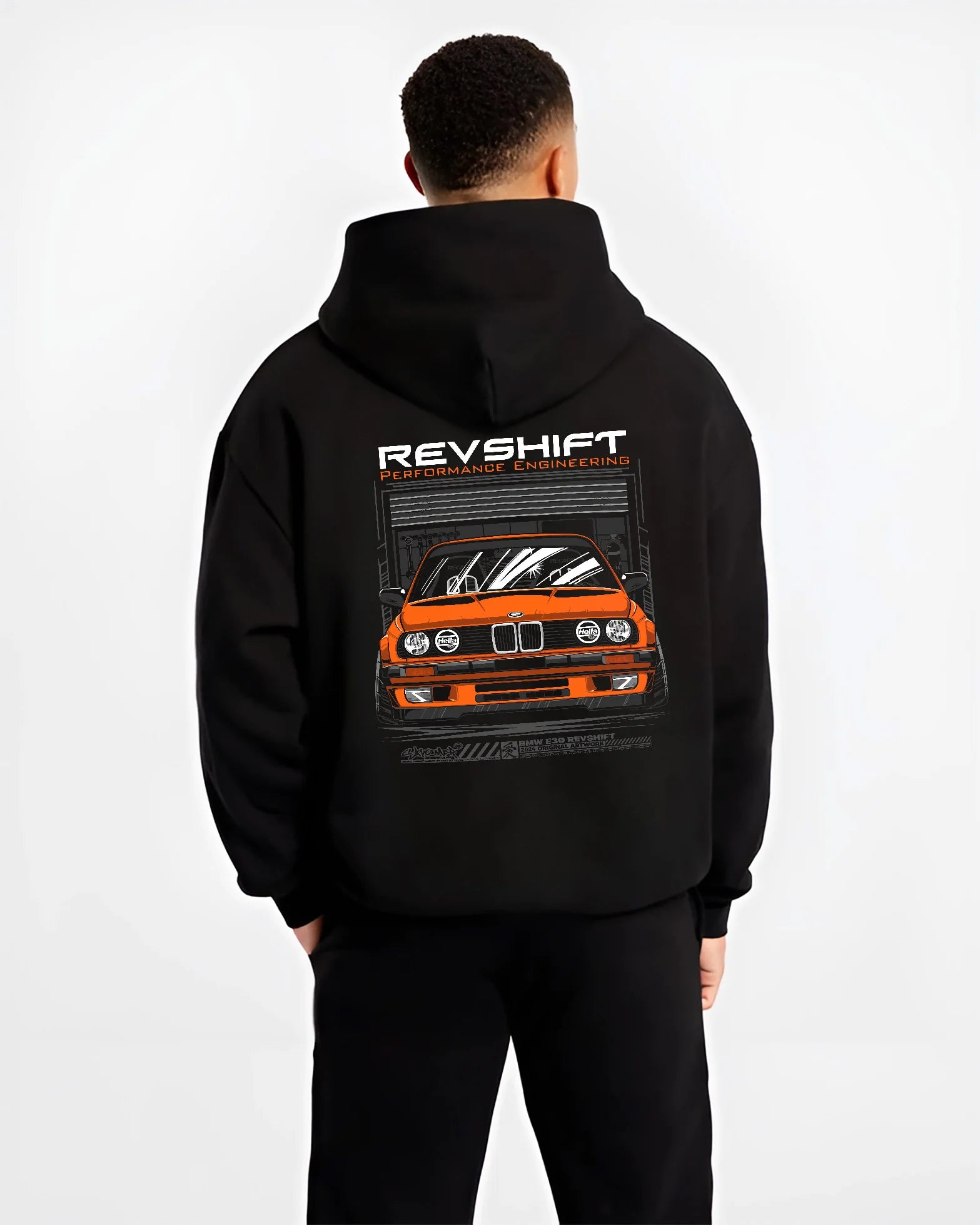 Black hoodie worn by a male model, back view, featuring BMW E30 rs motorsport street vintage classic racing graphic.
