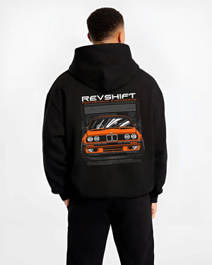 Black hoodie worn by a male model, back view, featuring BMW E30 rs motorsport street vintage classic racing graphic.