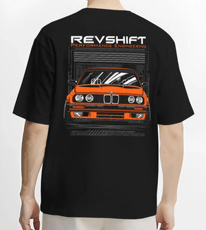 Black T-shirt worn by a male model, back view, featuring BMW E30 rs motorsport street vintage classic racing graphic.