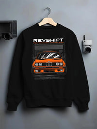 Black crewneck sweatshirt on a hanger against a grey wall, featuring BMW E30 rs motorsport street vintage classic racing graphic.