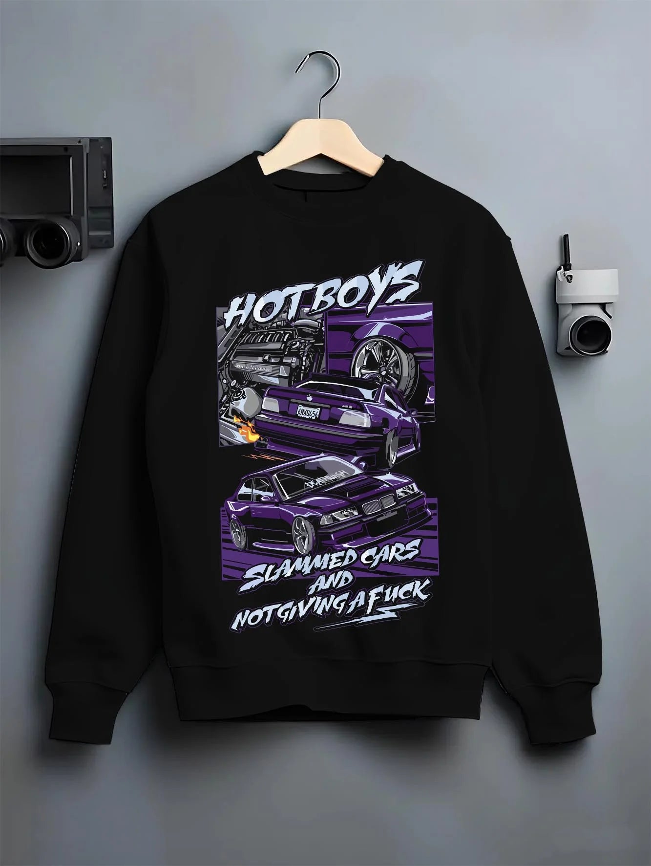 Black crewneck sweatshirt on a hanger against a grey wall, featuring BMW M3 rs turbo racing drift motorsport euro german graphic.