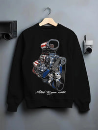 Black crewneck sweatshirt on a hanger against a grey wall, featuring v8 american muscle retro classic enthusiast racing graphic.