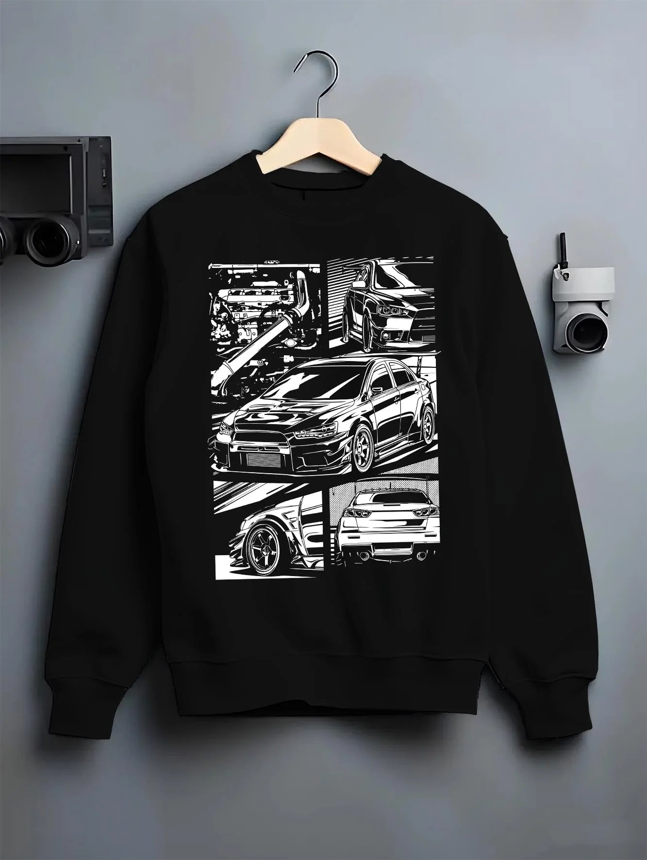 Black crewneck sweatshirt on a hanger against a grey wall, featuring Mitsubishi Lancer Evo X evo lancer turbo jdm racing graphic.