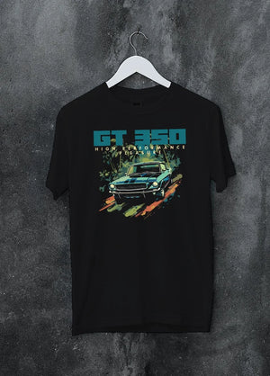 Black crewneck T-shirt on a hanger against a grey wall, featuring Ford Mustang street retro classic enthusiast racing graphic.