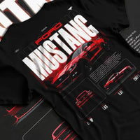 Black T-shirt laid flat with natural fabric folds, featuring Ford Mustang v8 american muscle street classic iconic power graphic.